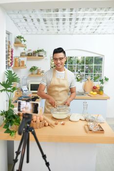 Food blogger recording video in his workplace