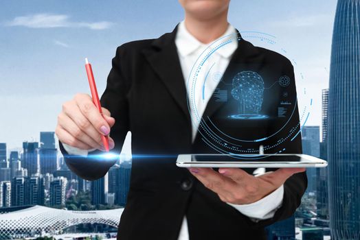 Woman In A Suit Virtually Writing On Screen Holding Tablet Showing Futuristic Technology. Businesswoman Wearing Uniform Handwriting Using Pad Presenting Modern Automation.
