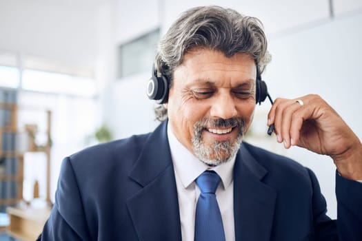 Senior businessman, call center and consulting in customer service, support or financial advisor at office. Mature man, consultant or agent smile with headphones in online advice or help at workplace
