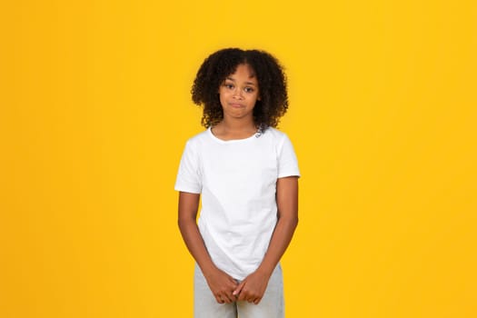 Calm sad offended adolescent african american girl in white t-shirt