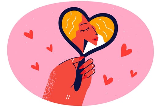 Woman look in heart-shaped mirror