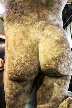 Back and ass of a Roman stone statue in the museum of Lisbon