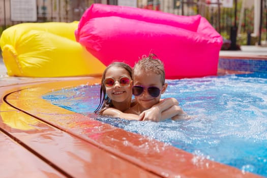 Two happy kids having fun in the pool