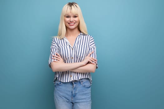 pretty european 20s woman in striped shirt on studio background