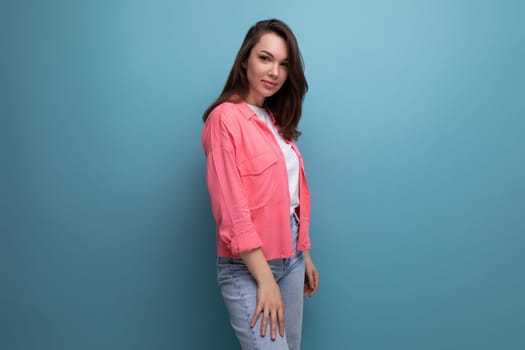 portrait of a young woman with hair below her shoulders in jeans and a shirt with copy space