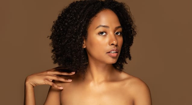 Sensual beautiful topless young black woman touching shoulder, panorama
