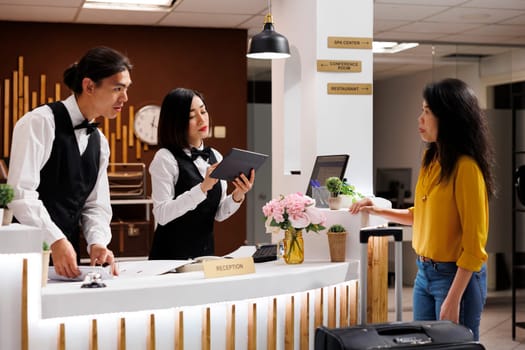 Asian concierge booking a customer