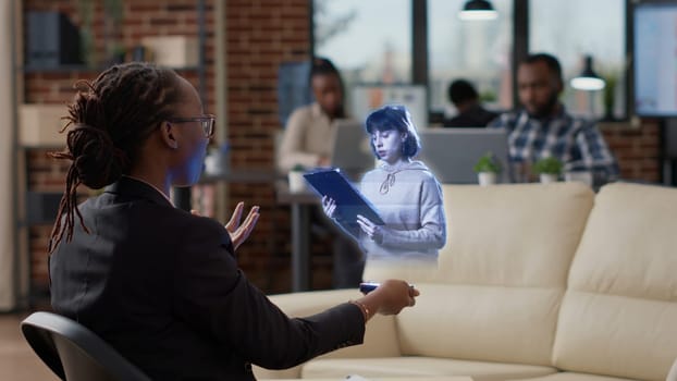 Team leader in AR teleconference meeting in innovative office greeting regional manager, showing team project progress. Employee in coworking space holding holographic online videocall with management
