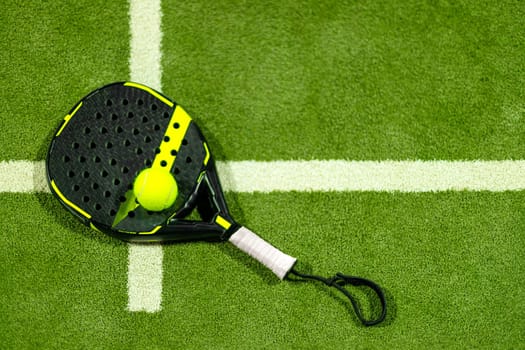 Padel tennis racket. Sport court and ball. Download a high quality photo with paddle for the design of a sports app or soical media advertisement
