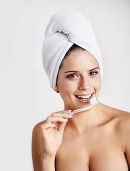 Woman, portrait and toothbrush for dental hygiene, teeth whitening and healthcare for gums in studio. Happy female person, smile and cleaning mouth for protection, brushing and white background