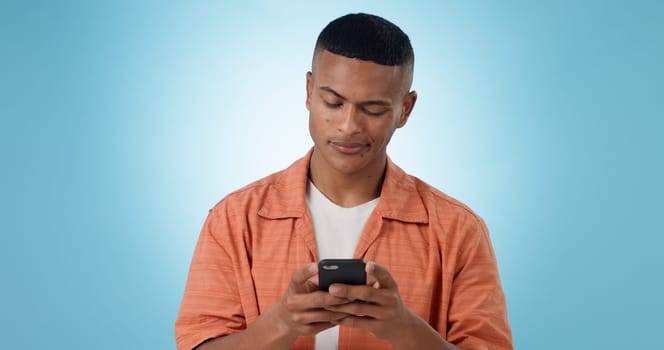 Doubt, confused and man with a smartphone, typing and connection on a blue background. Person, guy and model with a cellphone, mobile user and reaction with error 404, phishing and contact with app