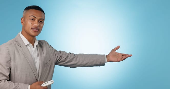 Weather forecast, portrait or man talking with hands for mockup space on blue background. Reporter, anchor or presenter in broadcast for presentation, climate change prediction or news in studio