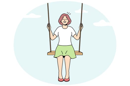 Smiling woman on swing in clouds
