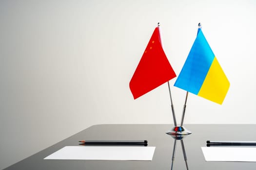 China and Ukraine flags on negotiation table