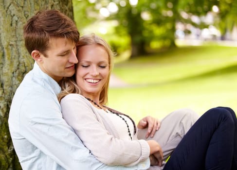 Nature, relax and happy couple hug, love and cuddle in outdoor park, green garden or grass field, pitch or lawn. Summer freedom, support and romantic man, woman or marriage people hugging on ground