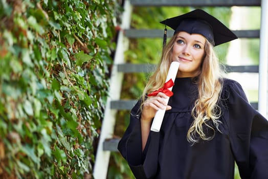 Student, graduation cap and woman thinking of future, university achievement and career choice or ideas. Graduate with education a diploma, law certificate and decision at outdoor campus or college