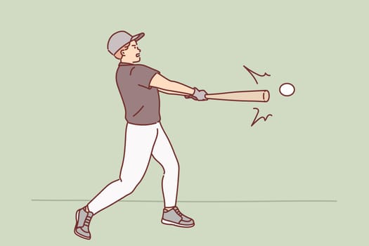 Man plays baseball while holding bat and hitting ball during training or tournament