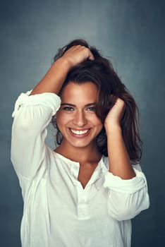 Woman, smile and portrait or pose, hair and studio background for fashion, style and proud or confident. Happy female person, beauty and face for cosmetics, glow and cool or retro clothing or vintage.