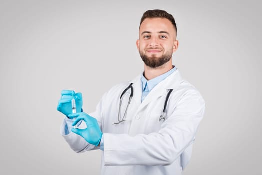 Doctor man holding syringe ready for vaccination