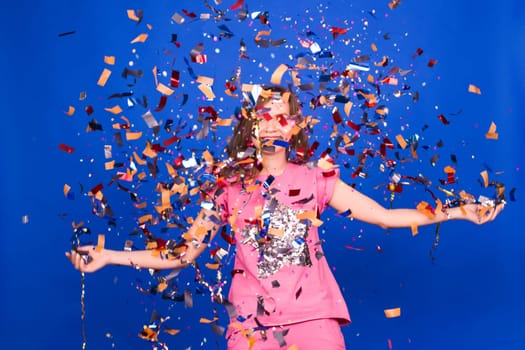 people, holidays, emotion and glamour concept - happy young woman or teen girl with confetti at party