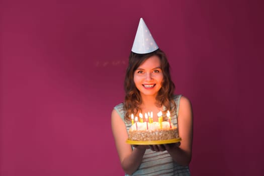 Portrait of pretty girl holding birthday cake