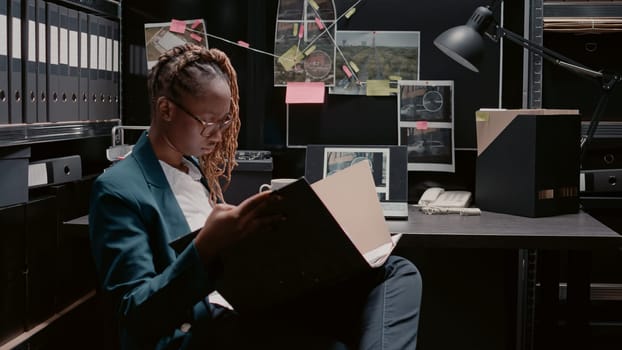 African american policewoman reviewing case files