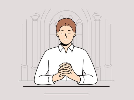 Man praying sitting on bench in temple seeking spiritual support in catholic and christian religion
