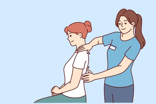Woman physiotherapist gives massage to patient to relieve shoulder or back pain after failed workout