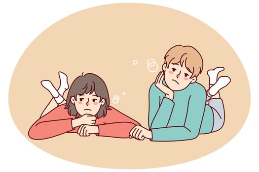 Bored kids lying on ground