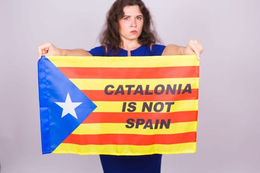 Portrait Of A serious catalan woman with estelada flag. Referendum For The Separation Of Catalonia From Spain. Democracy Independence Concept.