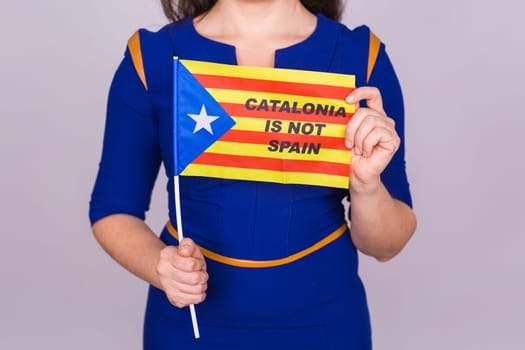 Portrait Of A serious catalan woman with estelada flag. Referendum For The Separation Of Catalonia From Spain. Democracy Independence Concept.