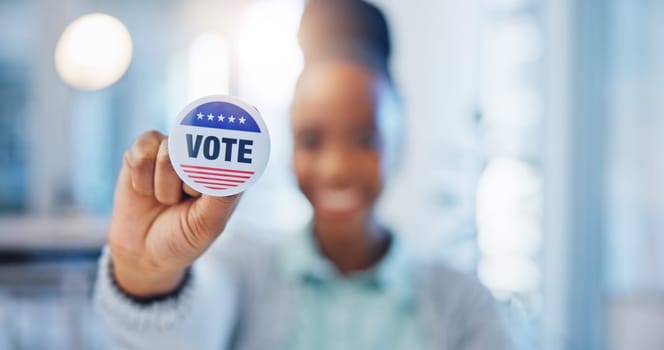 Hand, vote and badge with a black woman in government for support or motivation of a political campaign. Portrait, smile and democracy with a happy voter holding her pin of choice in a party election