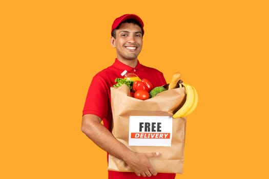 delivery worker guy holds paper food bag over yellow background