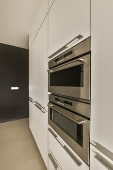 a kitchen with a stainless steel oven and white cabinets