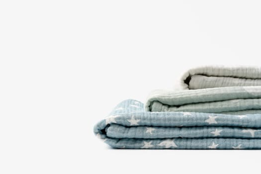 Three folded cotton blankets on white background