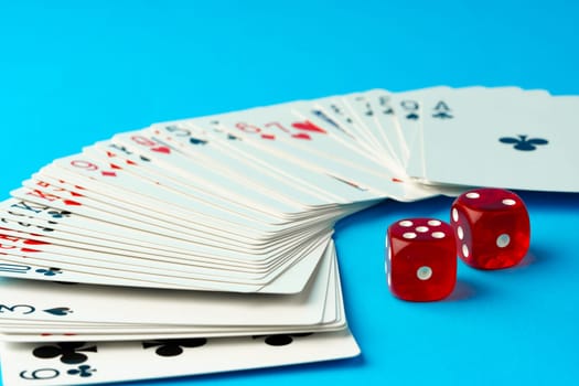 Playing cards and dices on blue background