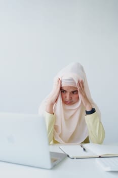 Muslim female employee working in office burnout.