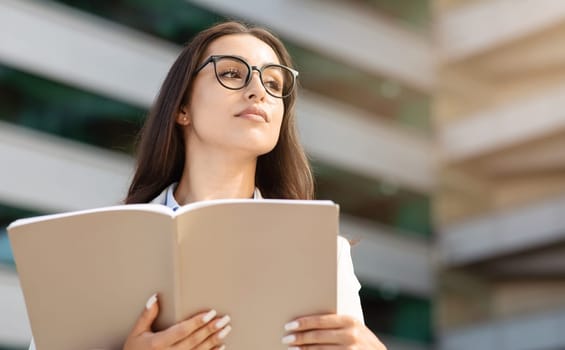 Serious calm confident millennial woman in glasses enjoy work, study, read book