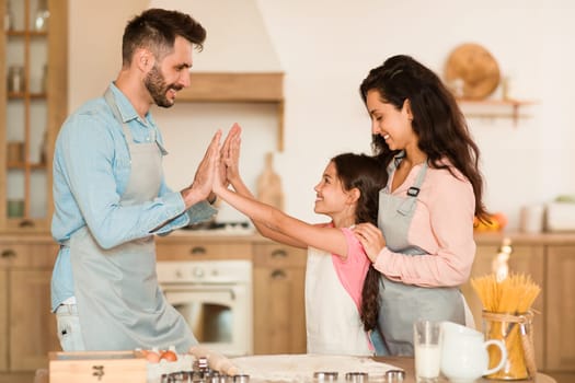 Family high-five during baking time