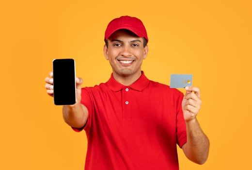 deliveryman with phone displaying credit card and empty screen, studio