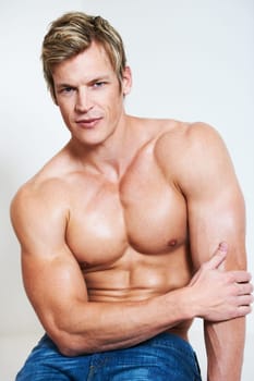 Man, portrait and muscle on studio background or serious confidence, bodybuilder or chest. Male person, model or face for shirtless masculine strength or flexing pose or attractive, strong in Norway