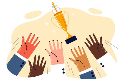 Gold cup for good teamwork over people hands symbolizes collaboration to achieve corporate success