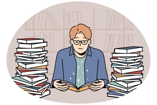 Young man with book pile reading and studying