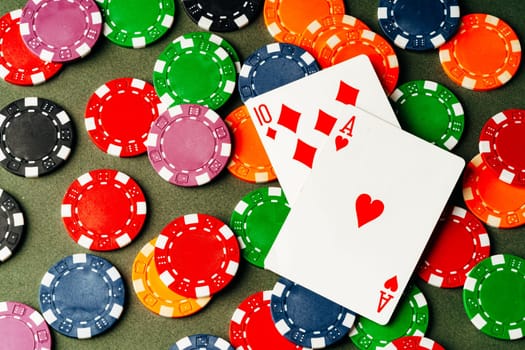 Playing cards and chips on green background