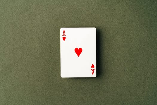 Ace playing card on green background close up