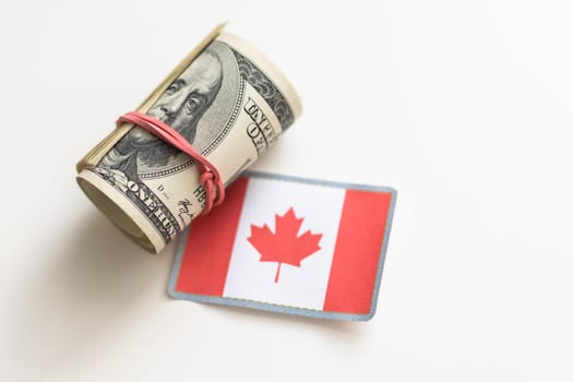 colorful waving canadian flag on a american dollar money background. High quality photo
