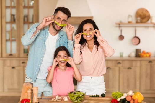Family having fun with food in kitchen