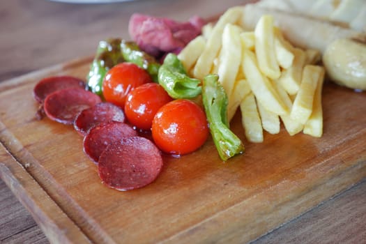 salami sausage served with tomato, chips and mushroom