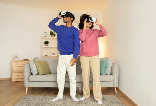 African American couple enjoys innovative VR gaming session at home