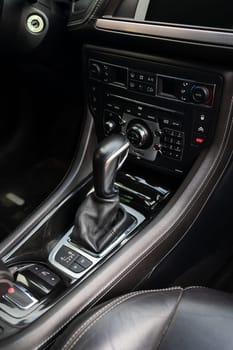 Close-up of an automatic transmission lever. Car interior, automatic transmission gear knob.